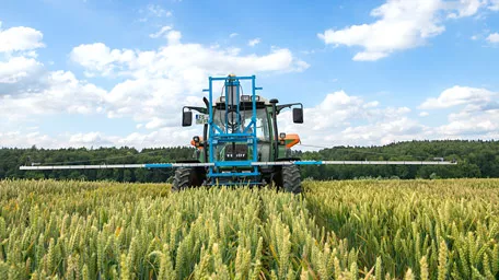 Tractor with multispectral sensor on a grain field
