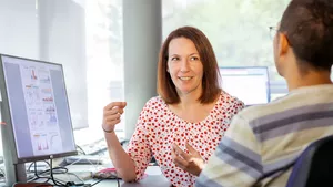 Melanie Schirmer talking to another researcher