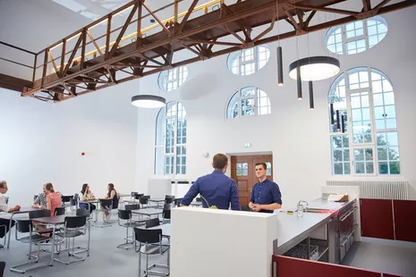 The foyer with double-height ceilings and historic walkway is perfect as a venue for small events.